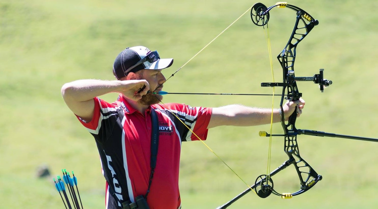 Archer shooting an arrow at an outdoor target